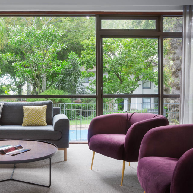 image of a lounge featuring maroon chairs